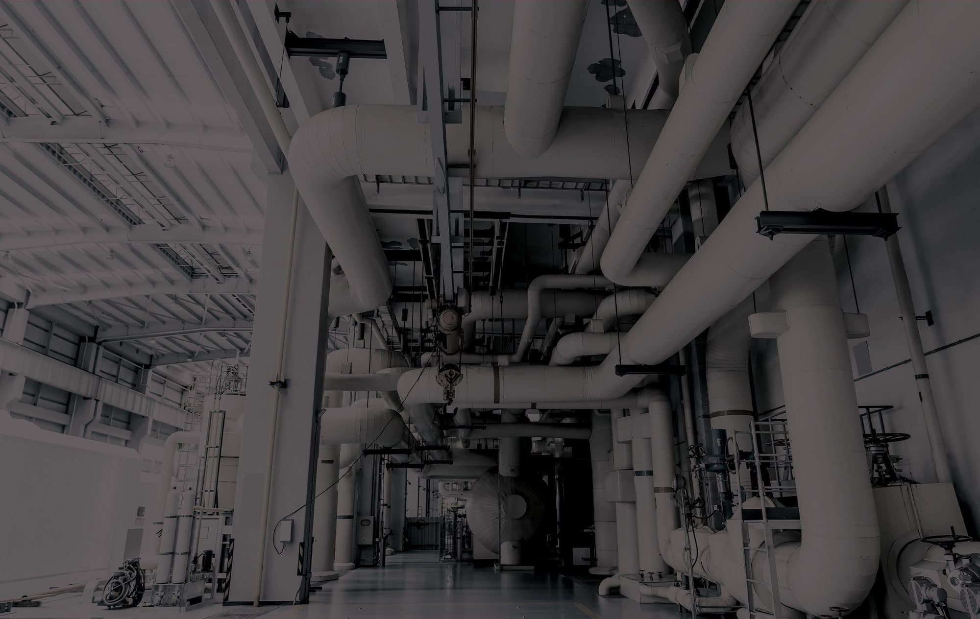 Industrial plant room with large insulated pipework